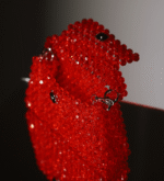 The Ignite Garnet Bag is a premium beaded handbag made with red crystals.