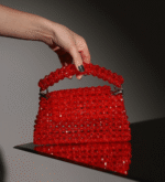 The Ignite Garnet Bag is a premium beaded handbag made with red crystals.